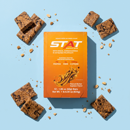 STAT Peanut Butter Espresso 12-count box with bar pieces on a light blue background